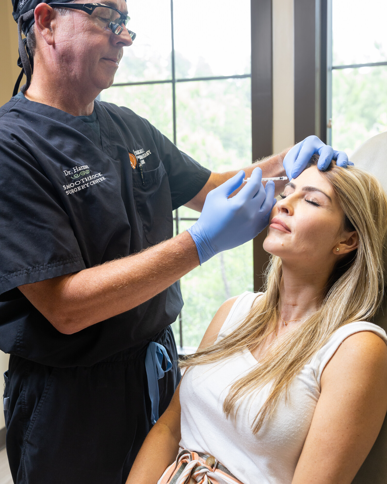 Dr. Harmon makes a cosmetic injection on a patient's forehead.