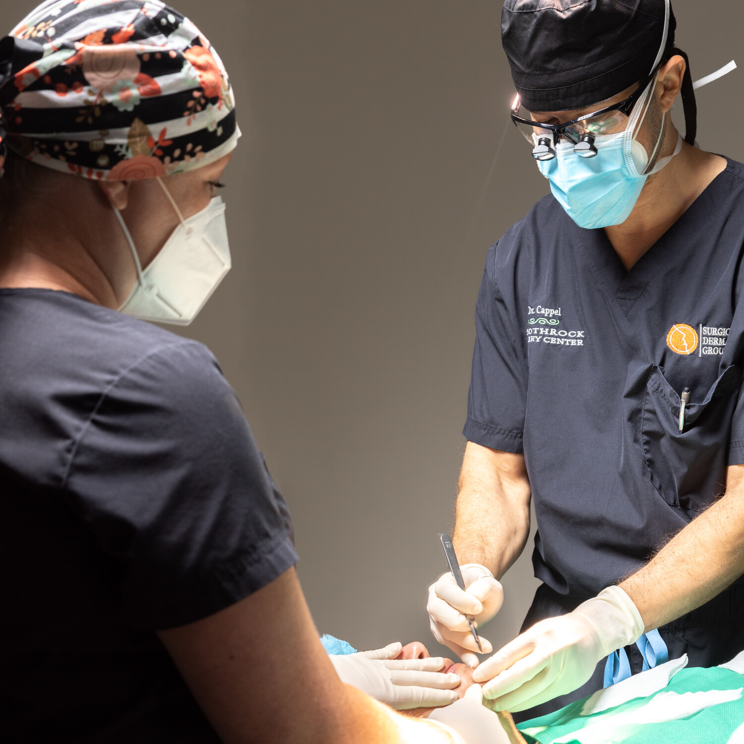 Dr. Cappel in surgery with another medical provider at Surgical Dermatology Group