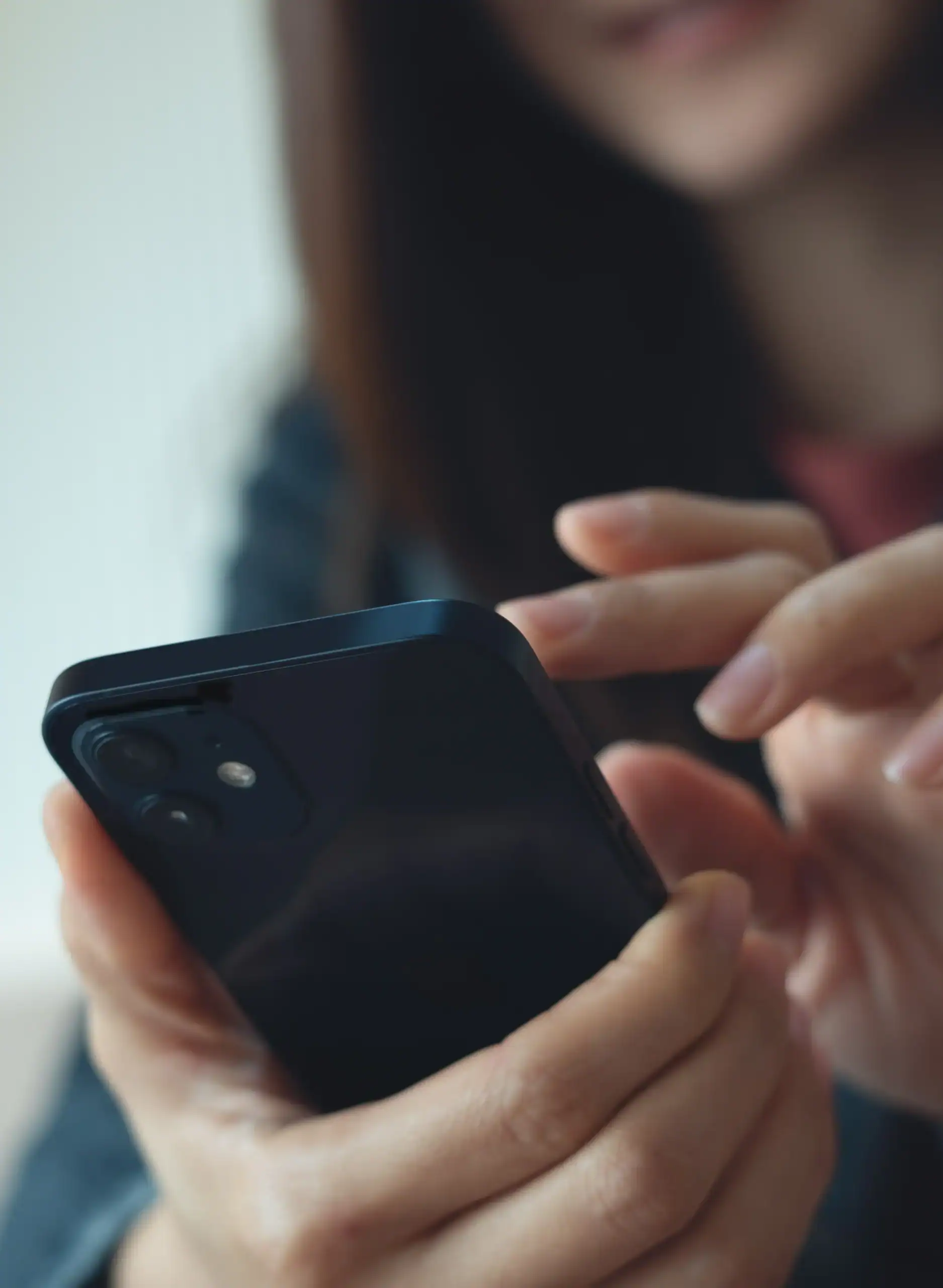 Woman uses a mobile phone